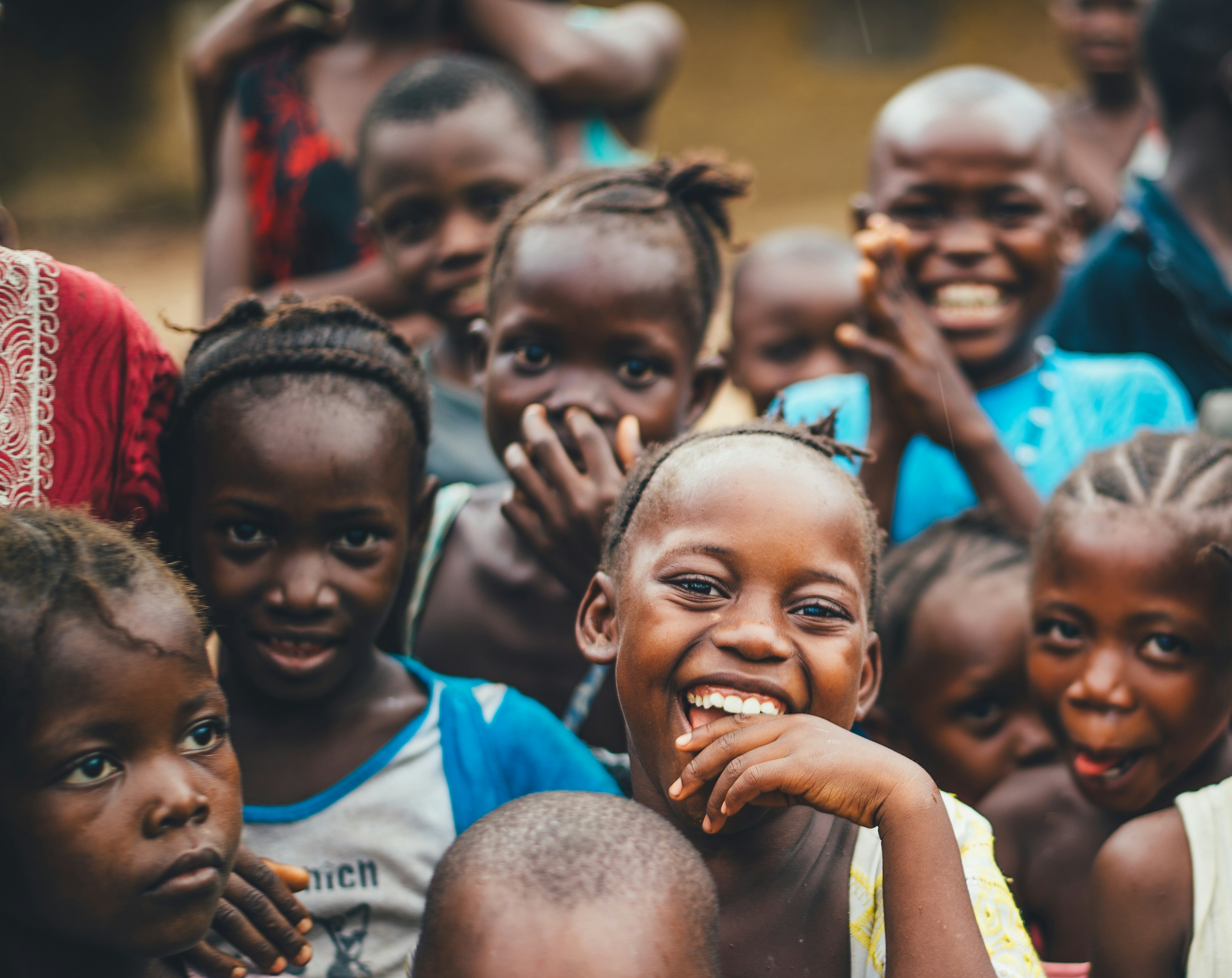 Children smiling joyfully at a school window